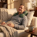 Man relaxing on a sofa using the Hushvale heated Shiatsu neck and shoulder massager